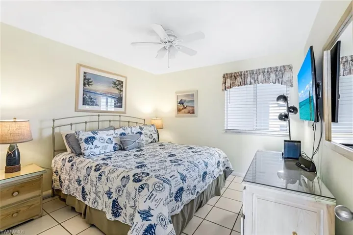 Bedroom featuring light tile patterned floors and ceiling fan