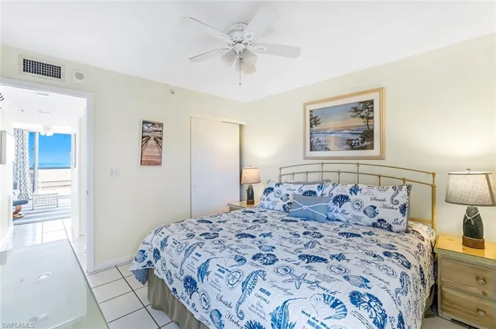 Bedroom with light tile patterned floors, a ceiling fan, and a closet