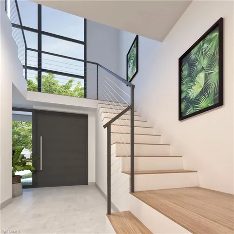 Entrance foyer with a high ceiling, stairway, and concrete flooring