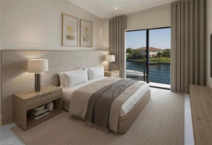 Bedroom with a water view, access to outside, and recessed lighting