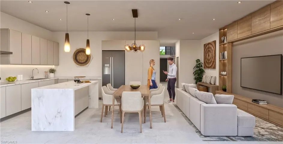 Kitchen with hanging light fixtures, modern cabinets, a kitchen island, high end refrigerator, and recessed lighting