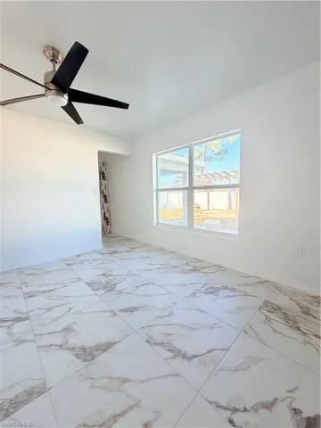 Empty room with light marble finish flooring and baseboards