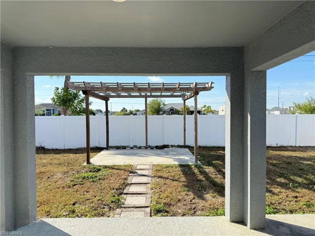 Fenced backyard featuring a pergola and a patio area