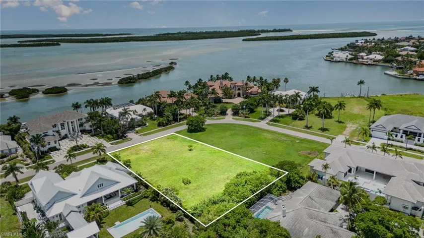 Birds eye view of property across from waterfront homes