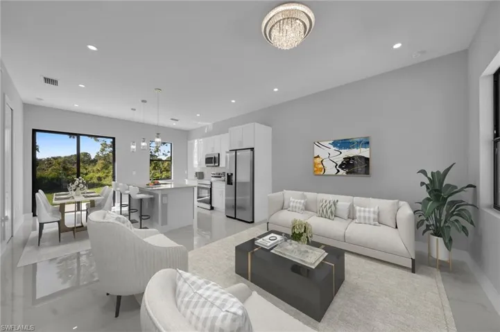 Living room featuring a chandelier and light marble finish flooring