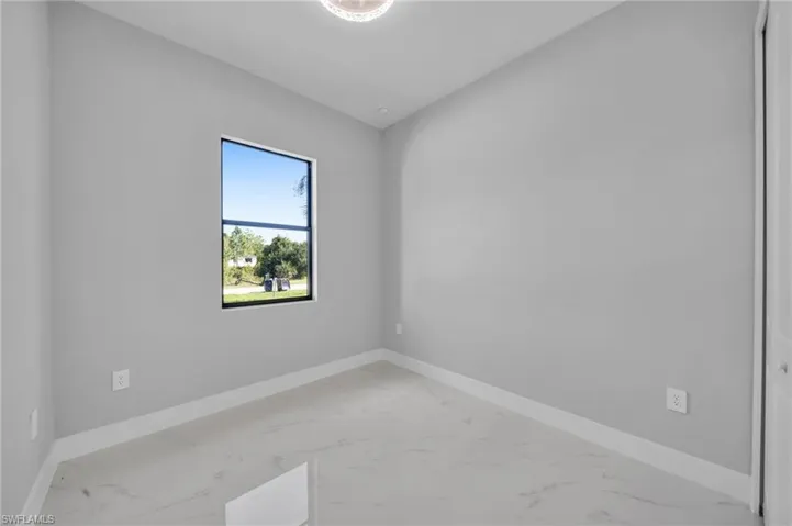Unfurnished room with baseboards and marble finish floors
