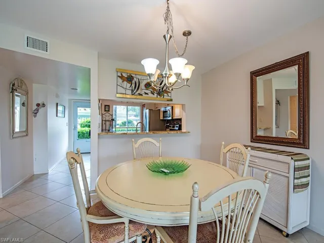 Dining area with a chandelier, sink, and light tile patterned floors