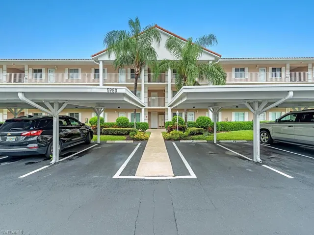View of car parking featuring a carport