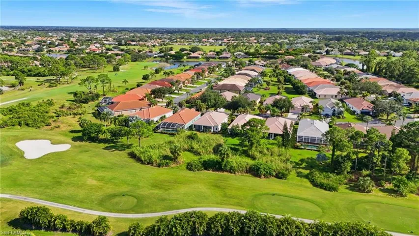 Aerial perspective of suburban area with a local golf course and a nearby body of water - Virtually Edited Image