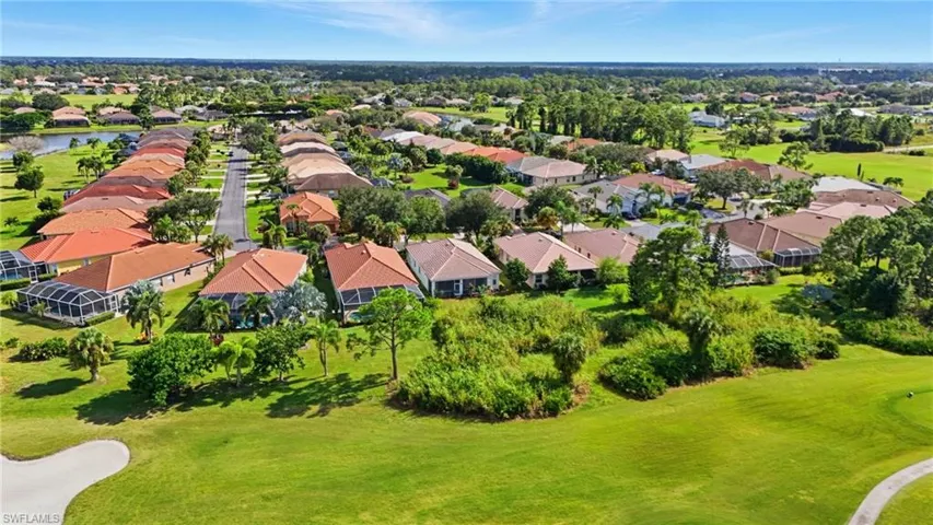 Aerial perspective of suburban area featuring a golf club - Virtually Edited Image