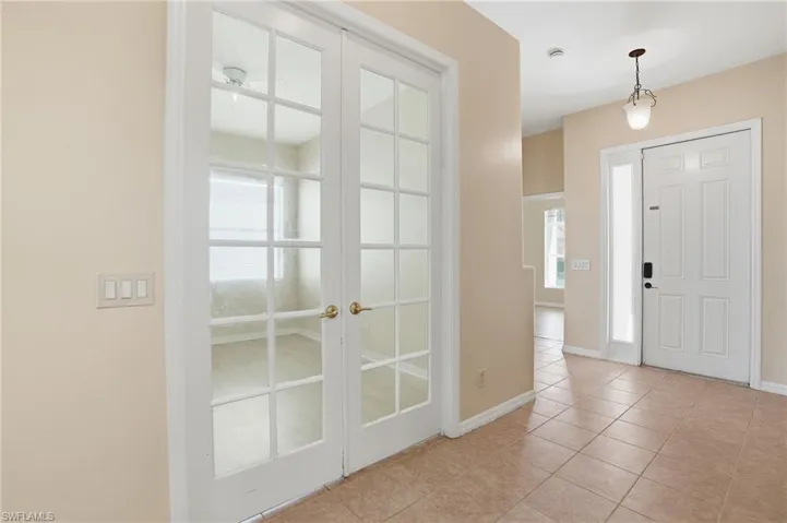 Foyer featuring light tile patterned flooring and french doors - Virtually Edited Image