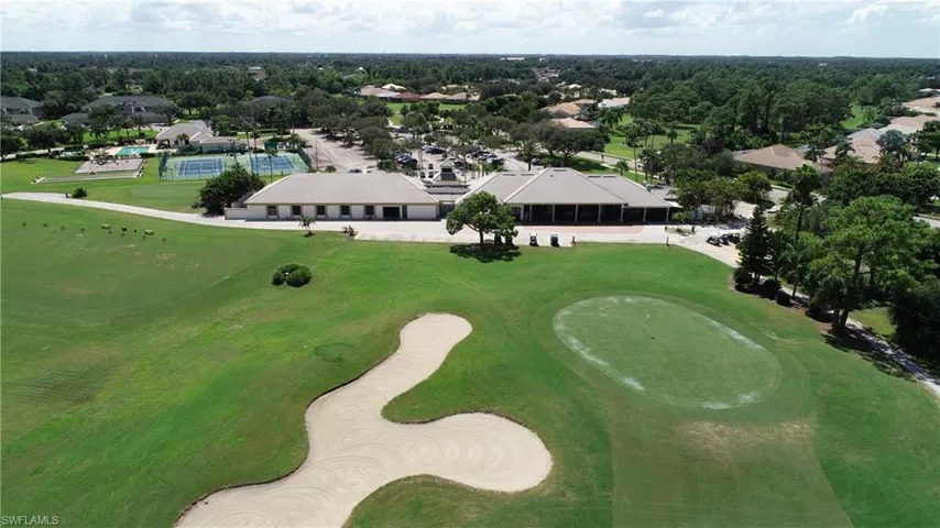 Aerial view of residential area featuring a local golf course