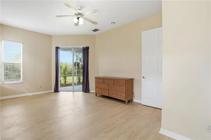 Unfurnished room with light wood finished floors and ceiling fan - Virtually Edited Image