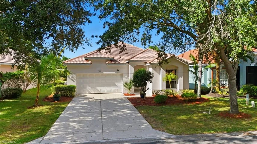 Mediterranean / spanish home with stucco siding, a tile roof, driveway, an attached garage, and a front yard - Virtually Edited Image