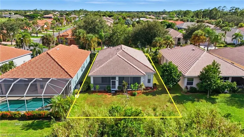 Aerial view of residential area with property boundaries highlighted - Virtually Edited Image