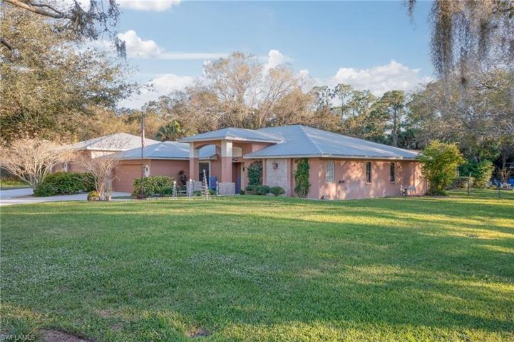 Lots of upgrades to the exterior including covered entryway, metal roof, brick accents and custom lighting.