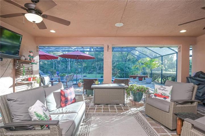 Such a relaxing outdoor space on this covered lanai overlooking the pool, spa and tropical back yard.
