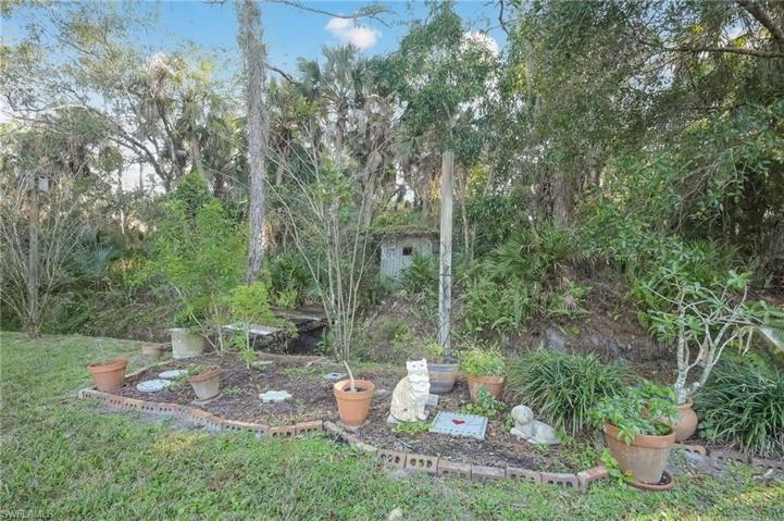 Backyard garden area and even a bridge to a fort for the kids!