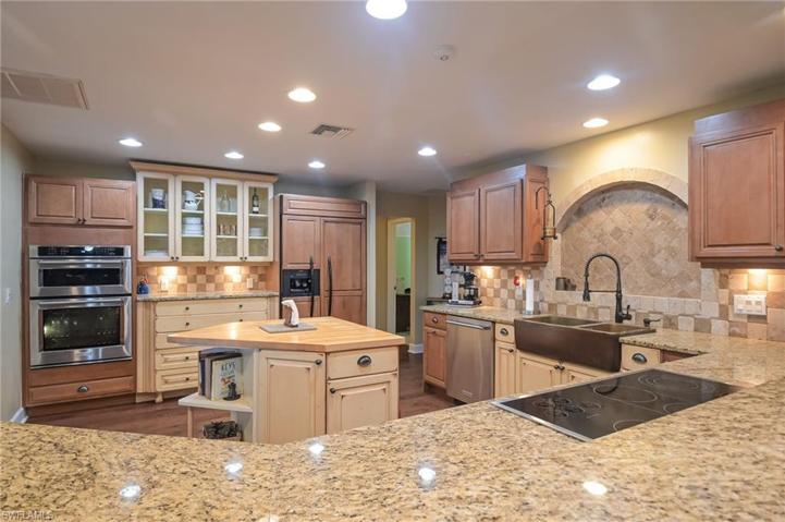 This country kitchen features some newer appliances including built in over and microwave, cooktop, dishwasher and built in refrigerator.