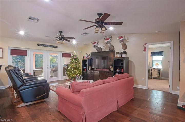 Relaxing living/family room with lots of natural light and double glass french doors to the pool and patio.