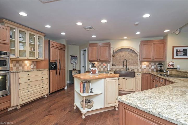Huge Country Kitchen with granite countertops, custom cabinetry, copper farm sink, tile backsplash and even a custom built in refrigerator!