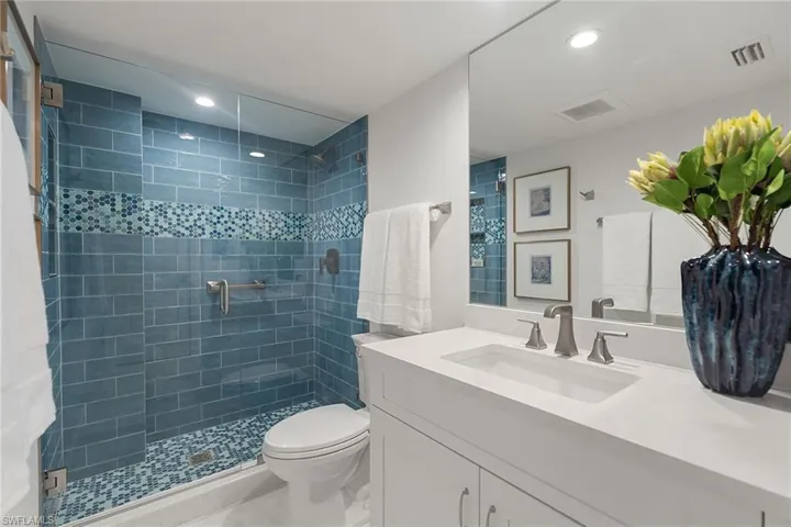 Full bath with vanity, a stall shower, and recessed lighting