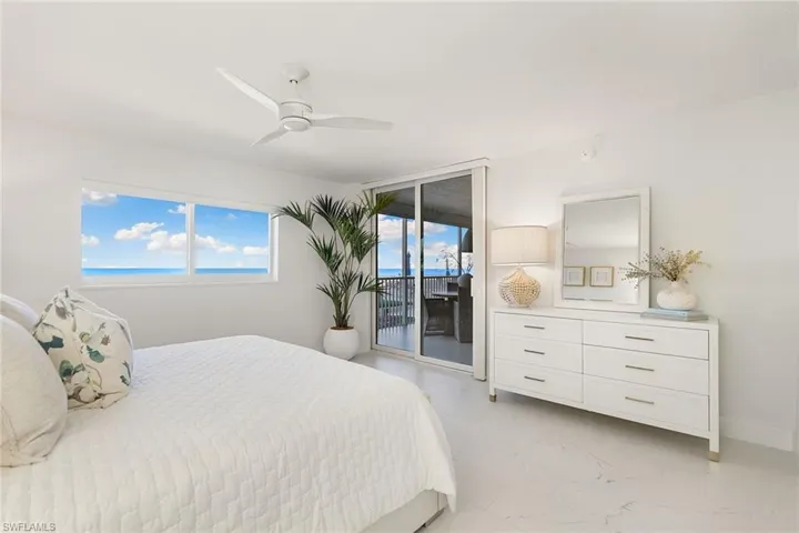 Bedroom with light tile finish floors, access to exterior, and ceiling fan
