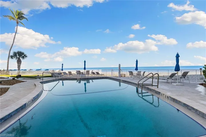 Community pool featuring a patio and a water view