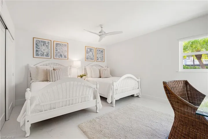 Bedroom with a closet, ceiling fan, and  tile flooring