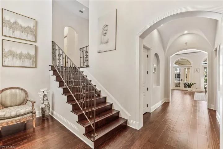 The entrance foyer on the first floor with dark wood-type flooring