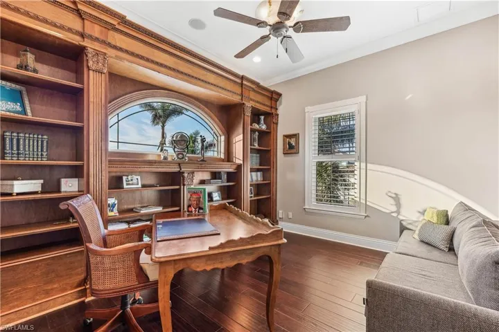 A large office /den with extensive built-in furniture