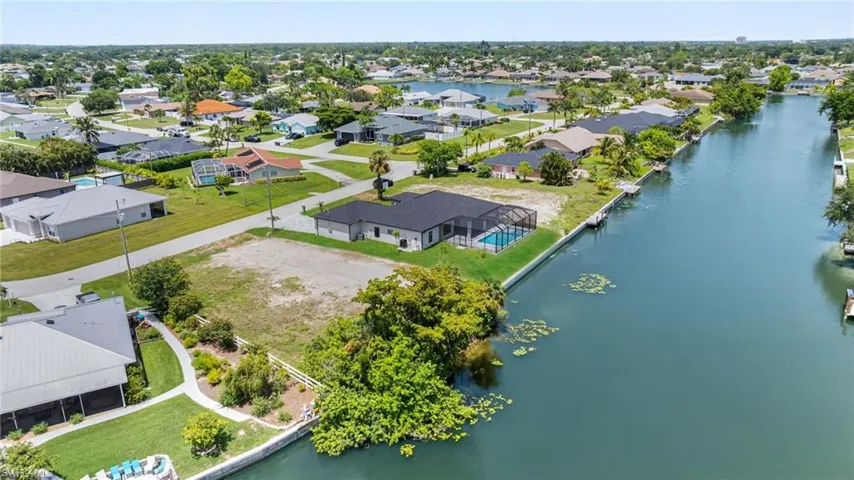 Aerial perspective of suburban area with a nearby body of water