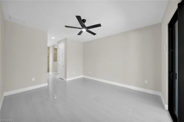 Empty room with a ceiling fan and recessed lighting