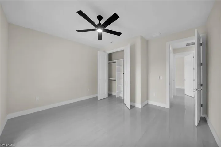Unfurnished bedroom with a closet, a ceiling fan, and wood finished floors
