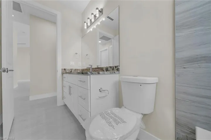 Bathroom featuring vanity and baseboards