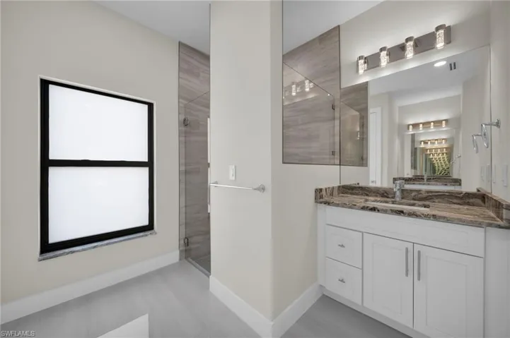 Full bath with a stall shower and vanity