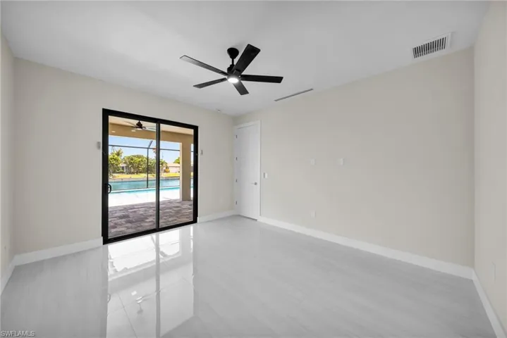 Unfurnished room featuring ceiling fan and light tile patterned floors