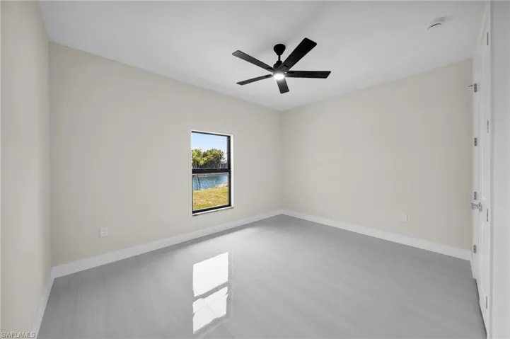 Spare room with a smoke detector and a ceiling fan