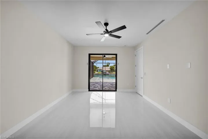 Unfurnished room with ceiling fan and light tile patterned flooring