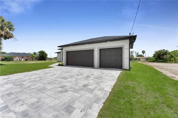 Garage featuring decorative driveway