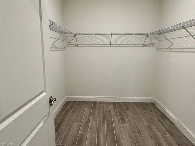 Walk in closet featuring wood tiled floors