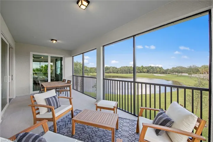 Sunroom / solarium featuring an outdoor hangout area, a wealth of natural light, and a water view