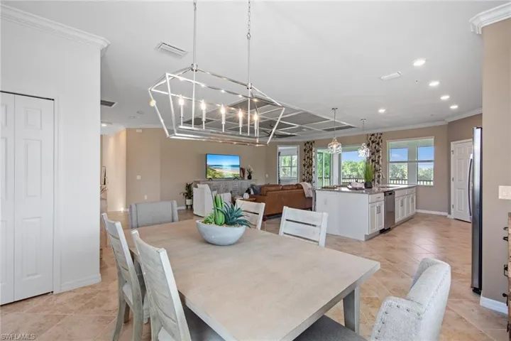 Dining room featuring a chandelier, crown molding, visible vents, and recessed lighting