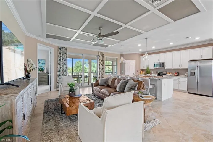 Living room with recessed lighting, ceiling fan, ornamental molding, and coffered ceiling