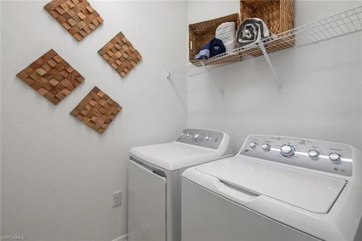 Laundry area featuring washer and clothes dryer and laundry area