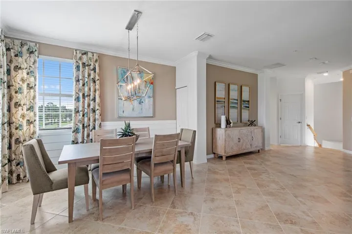 Dining space featuring a chandelier, visible vents, and ornamental molding