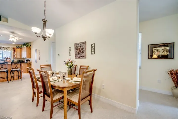 Dining area featuring a ceiling fan and a chandelier