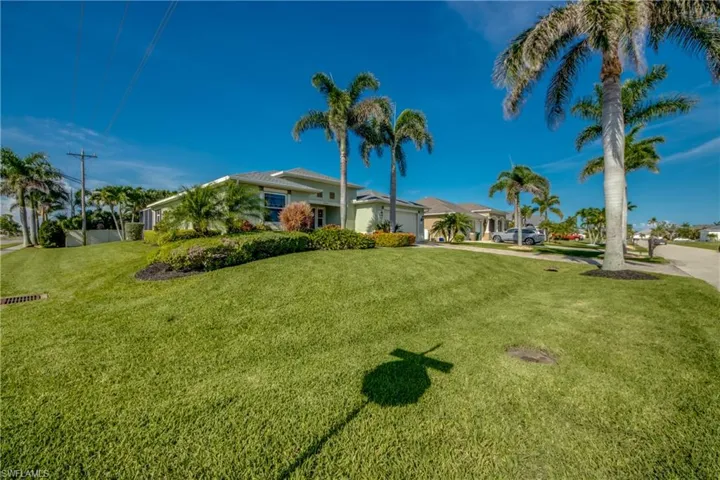 View of front of house with an attached garage, a front yard, and concrete driveway