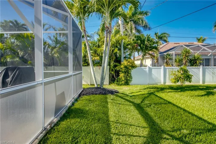 Fenced backyard with a lanai