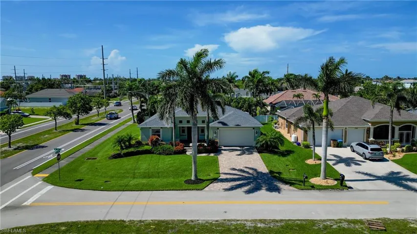 View of front facade with driveway, a garage, a front yard, and a residential view